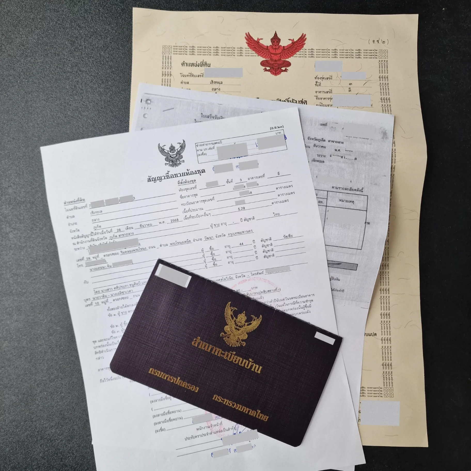 Thai chanote title deed, condominium sale contract, and house registration book — title review with local counsel